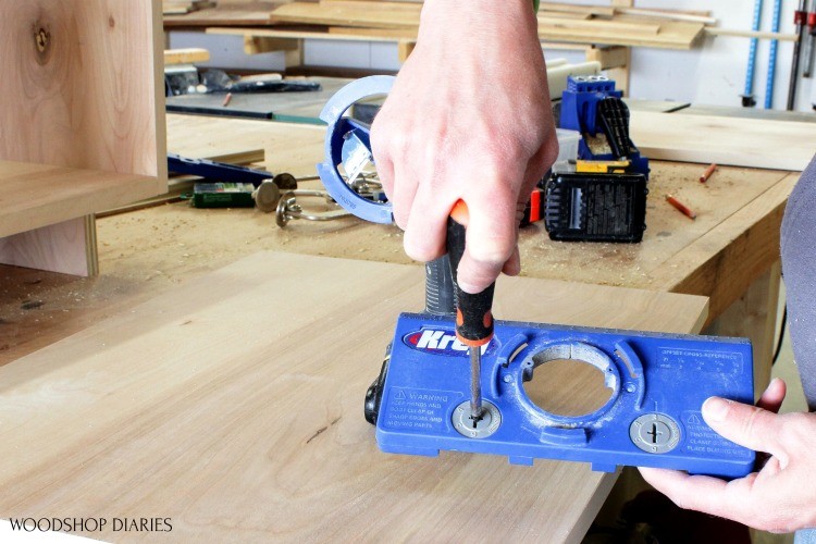 Adjusting spacing blocks on concealed hinge jig using screwdriver