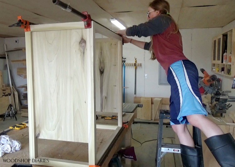 Shara on ladder clamping dresser frame together 