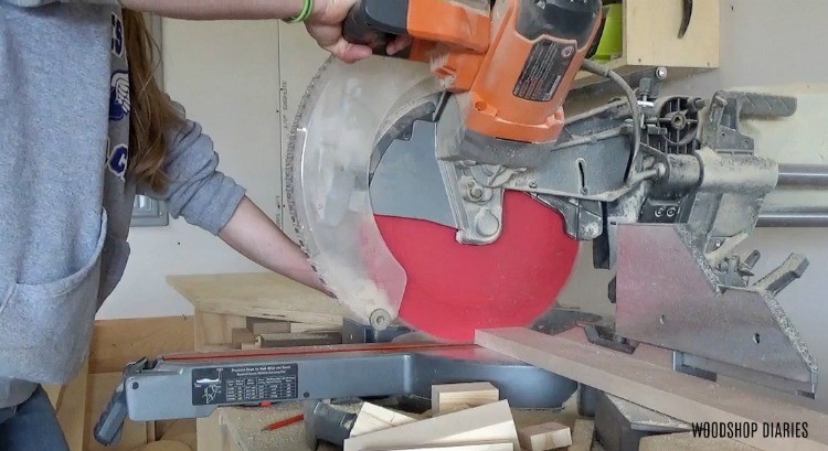 Use miter saw to trim mirror frame boards to length