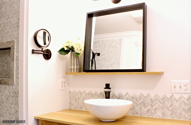 Modern floating bathroom mirror installed during all star renovation challenge