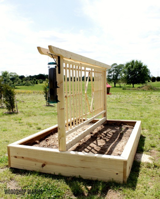 DIY Garden Bed with Trellis design angled view with birdfeeders hanging on sides