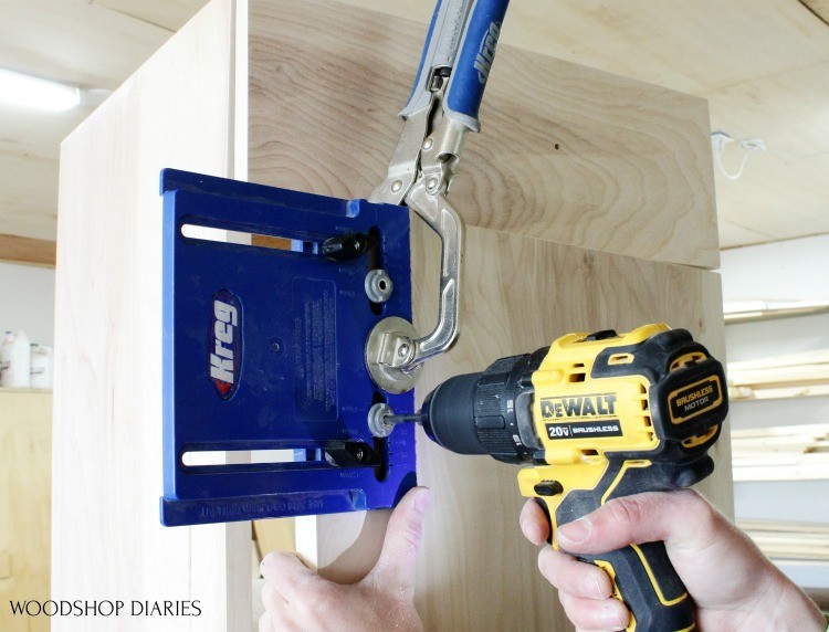 Clamp cabinet hardware jig on cabinet door to drill holes for door pulls