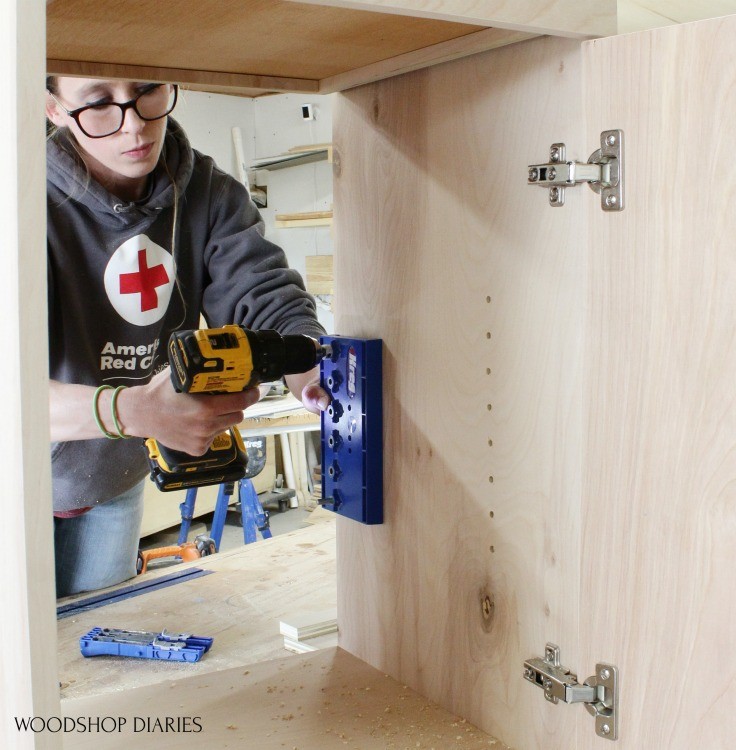 Using pin to drill shelf pin holes into cabinet box sides