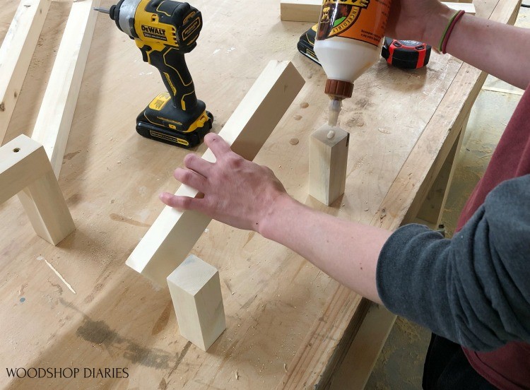 Applying glue to short towel rack pieces before adding screws