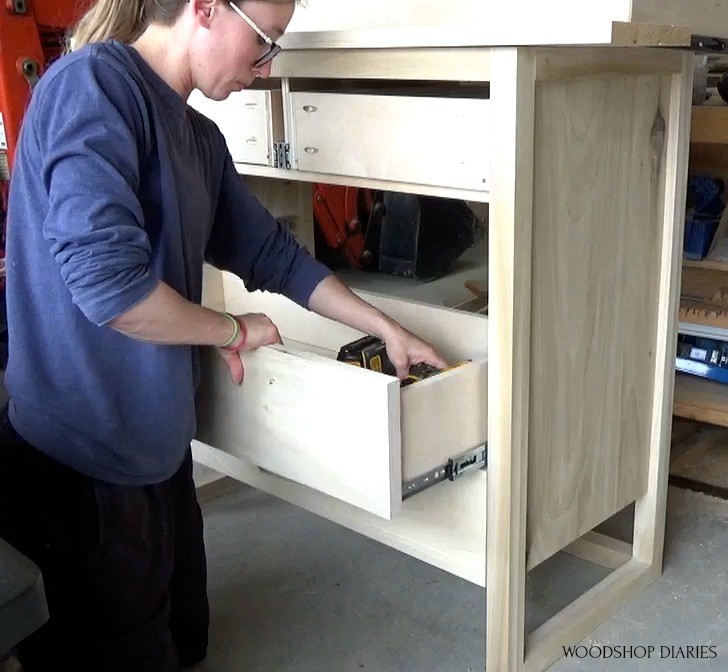 Screwing drawer front onto drawer box from inside to hide the screws