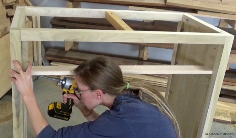 Shara Woodshop Diaries installing scrap plywood pieces to use as dresser drawer divider