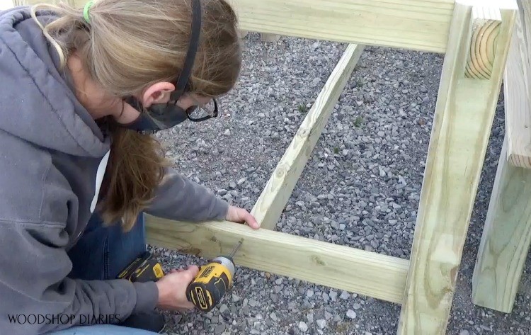 Attaching long bottom trestle between table leg sides using 2 ½" wood screws