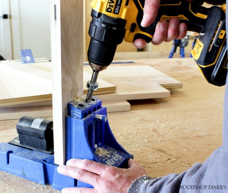 Drilling pocket hole with Kreg K5 into plywood piece to build cabinet