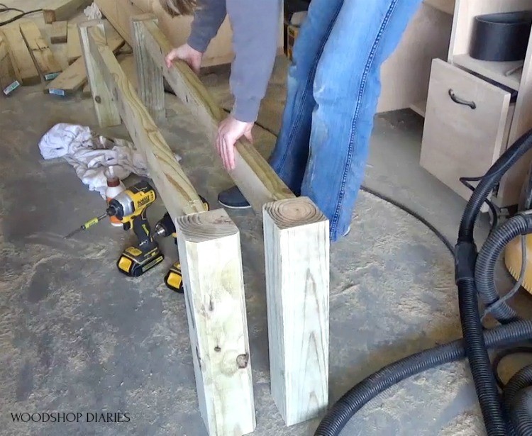 Two long trestle table matching bench sides assembled in workshop