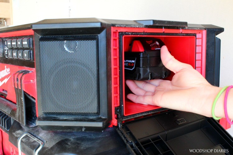 Shara Installing battery pack into weather tight compartment of Milwaukee PACKOUT radio
