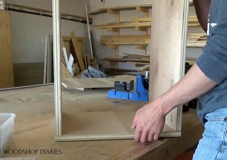 Body of scrap plywood stool assembled on workbench