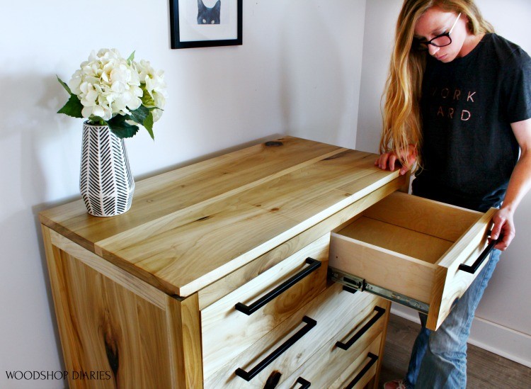 Shara looking into top drawer of finished Modern poplar dresser