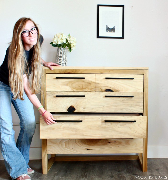 Shara Woodshop Diaries pulling drawer of DIY modern 5 drawer dresser out to show it off