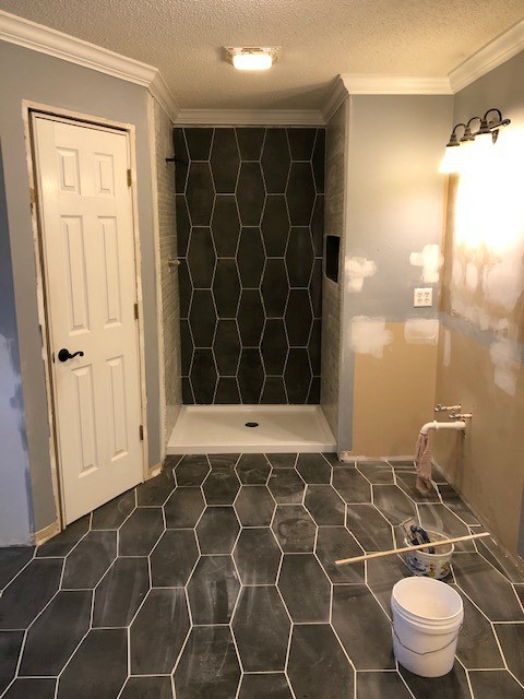 Bathroom renovation tiles grouted on floor and shower walls