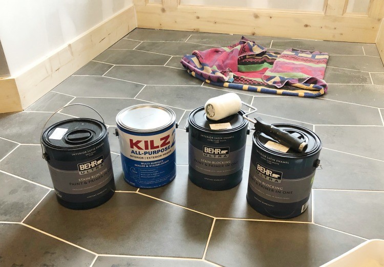 Behr Paint Cans ready to be opened and put to use on the bathroom walls