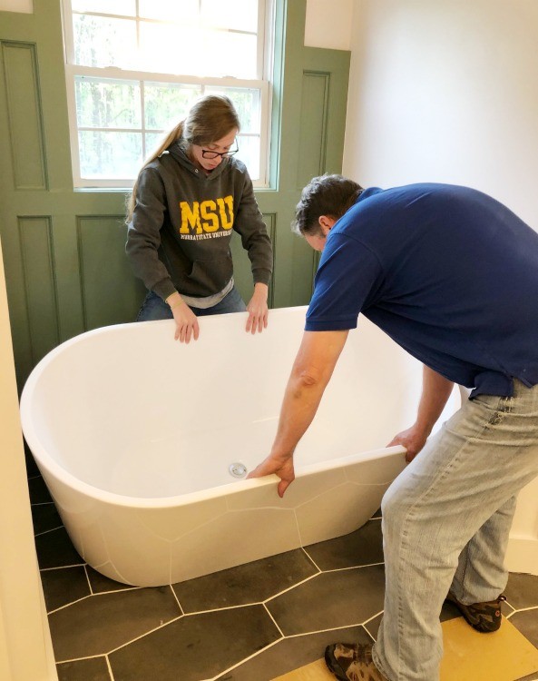 Shara and Dad placing tub in bathroom