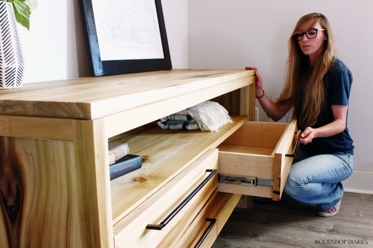 Shara Pulling drawer out of DIY modern dresser to look inside