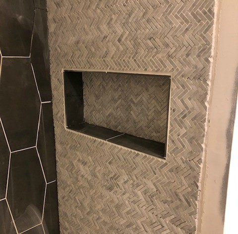 Tile around shower niche in master bathroom after grout