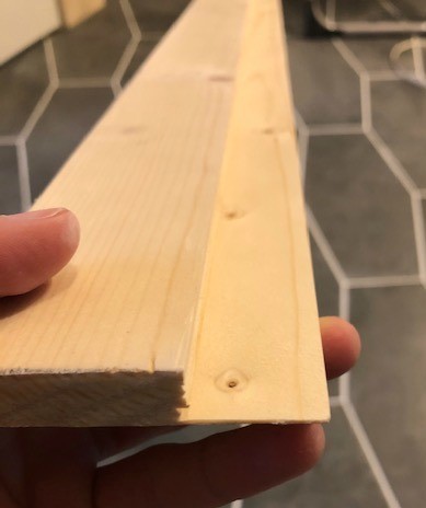 Close up of rabbet cut on shower edge trim piece