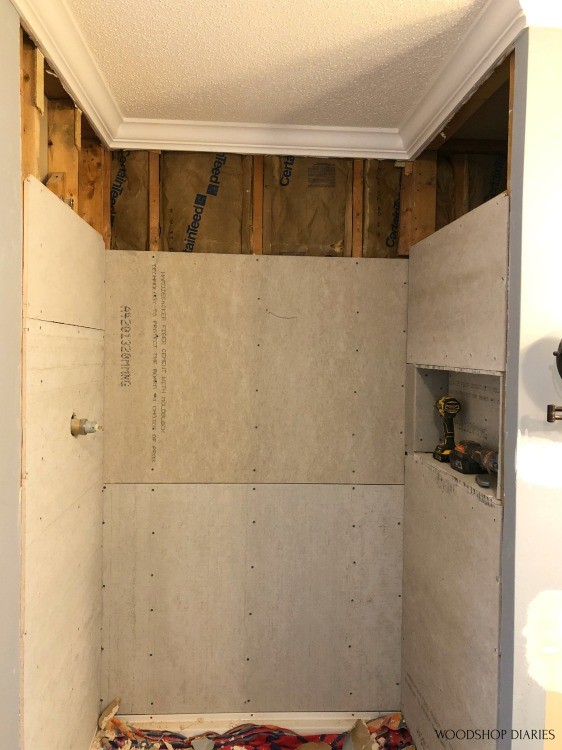 Shower nook with upper drywall removed ready to replace