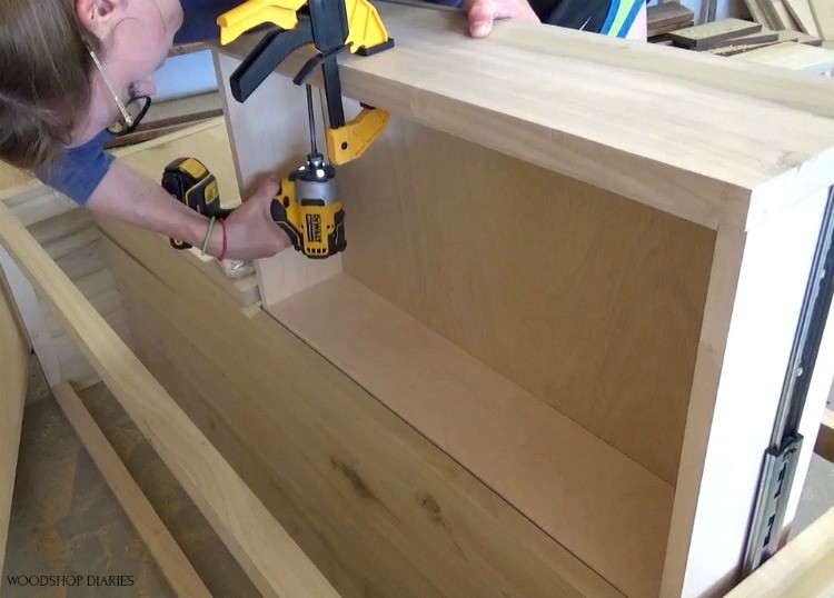 Shara screwing drawer fronts onto drawer boxes from inside