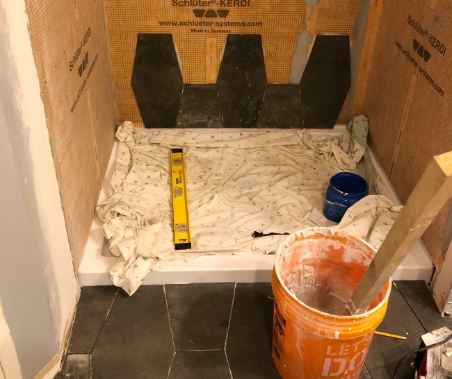 Bottom row of shower tile started to match the flooring