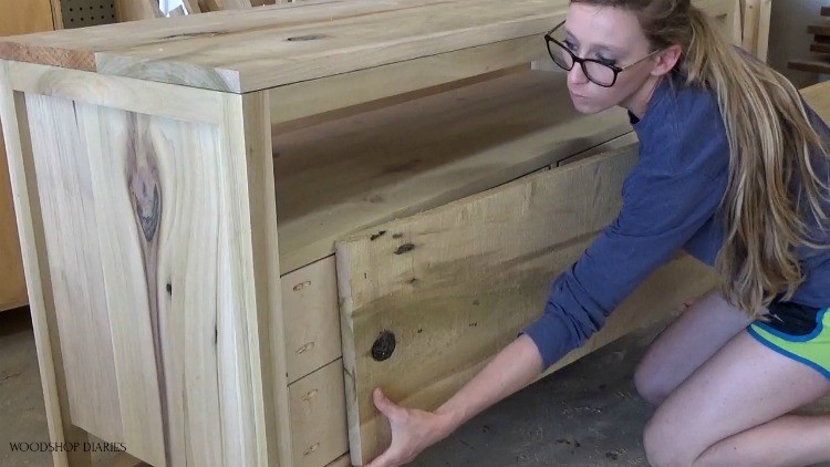 Shara holding up wide board to use for drawer fronts