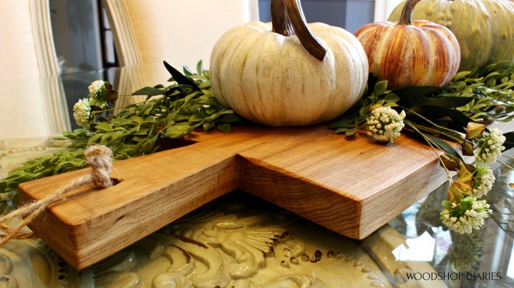 Close up of handle on DIY serving board decorated with pumpkins as a fall centerpiece idea