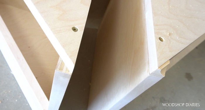 Close up of little cove trim placed on nesting table seat corners