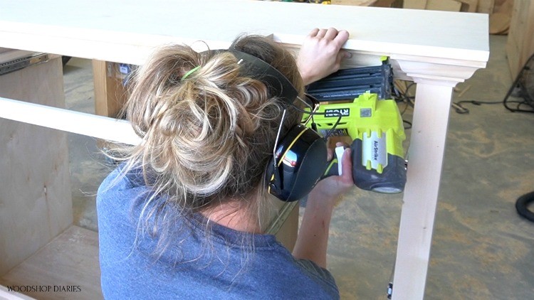 Shara brad nailing crown molding into top of console cabinet