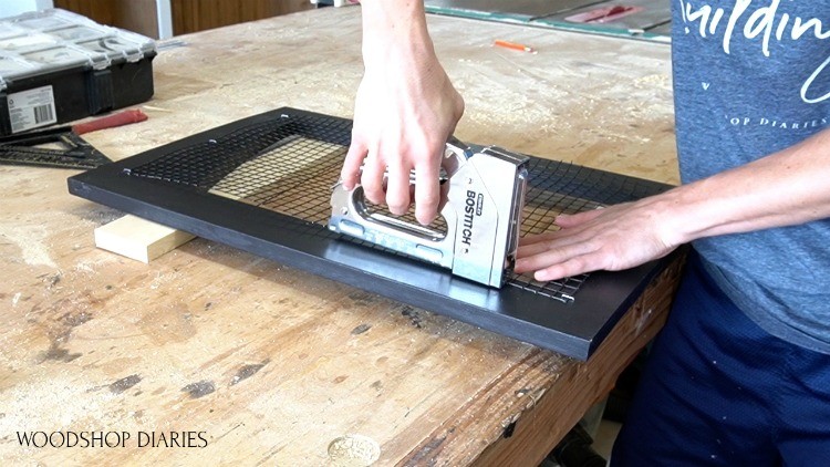 Stapling hardware mesh cloth onto back of dog crate doors