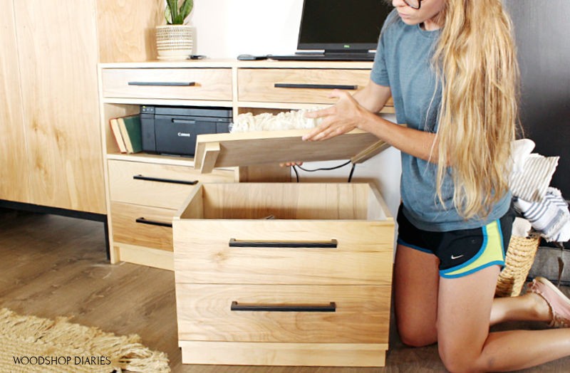 Shara lifting lid on storage seat of dresser desk