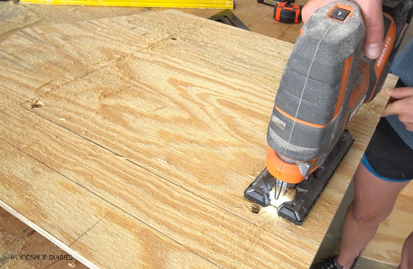 Using a jig saw to trim hole for door opening on blessing box