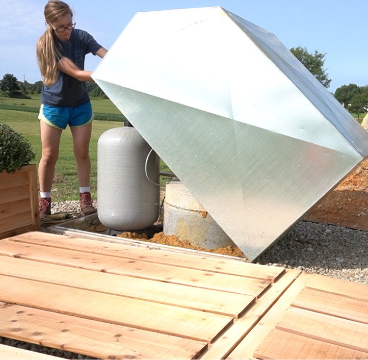 Opening well house cover with fence lying on ground--easy to lay down or prop up as needed