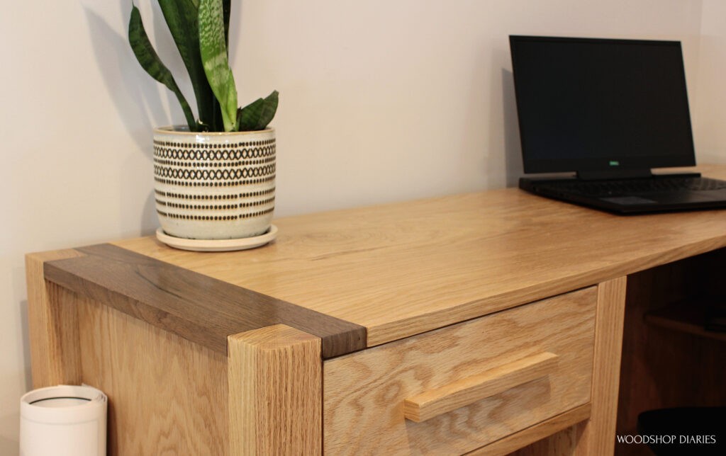 Close up of two tone--walnut and oak--corners on l shaped finished desk