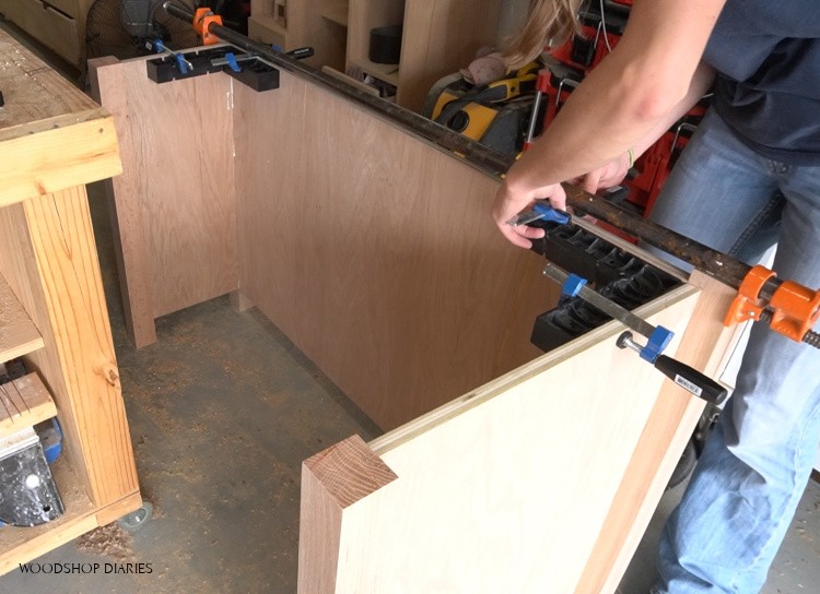 Using corner clamps to glue up right desk cabinet