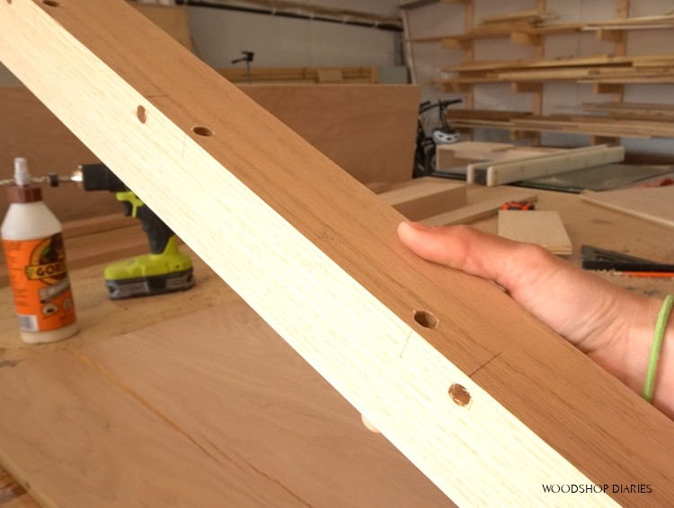 Dowel holes drilled in corner desk leg post for assembly