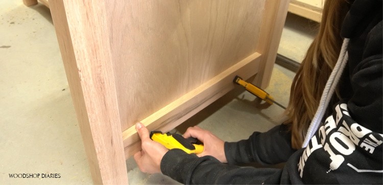 Glue trim pieces onto desk cabinets