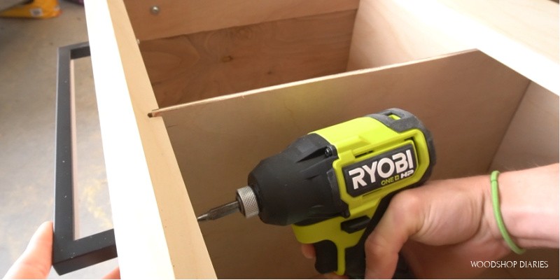 Close up of Ryobi ONE+ HP driver installing drawer pulls in filing cabinet
