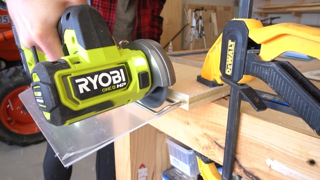 Close up of Ryobi ONE+ HP cut off tool cutting plastic sheet