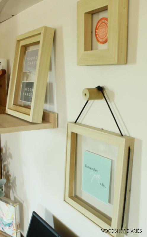 simple floating frames hanging on wall above office desk