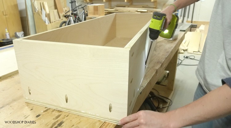 Attaching bottom panel of bench storage box