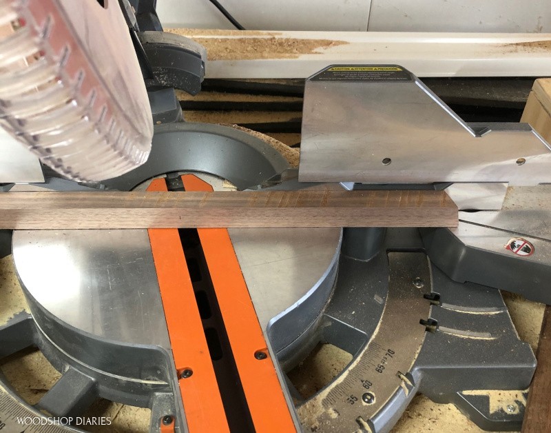 miter saw set up to cut compound angles for corner posts of wooden Christmas tree