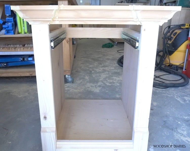 Close up of drawer slides installed into real life cabinet in workshop