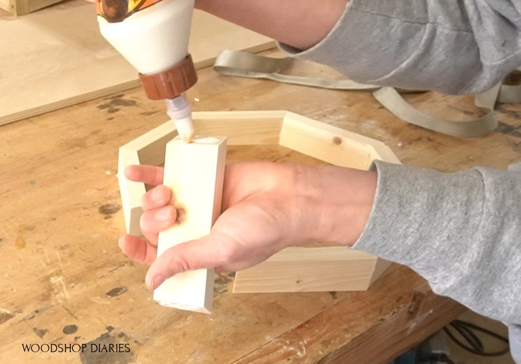 Applying glue to octagon edges to assemble tray sides