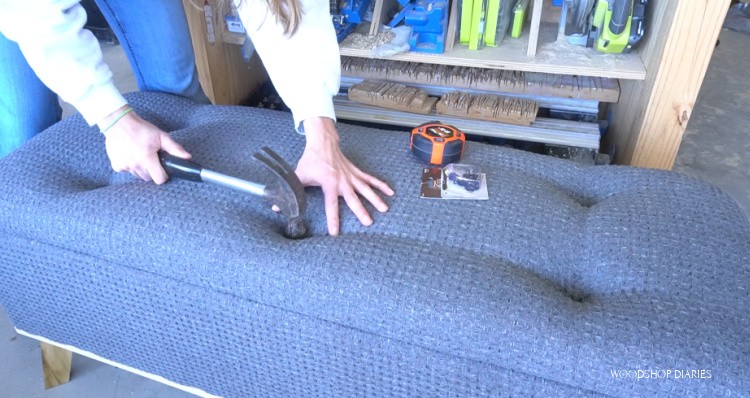 Using a hammer to tuft upholstered bench top seat