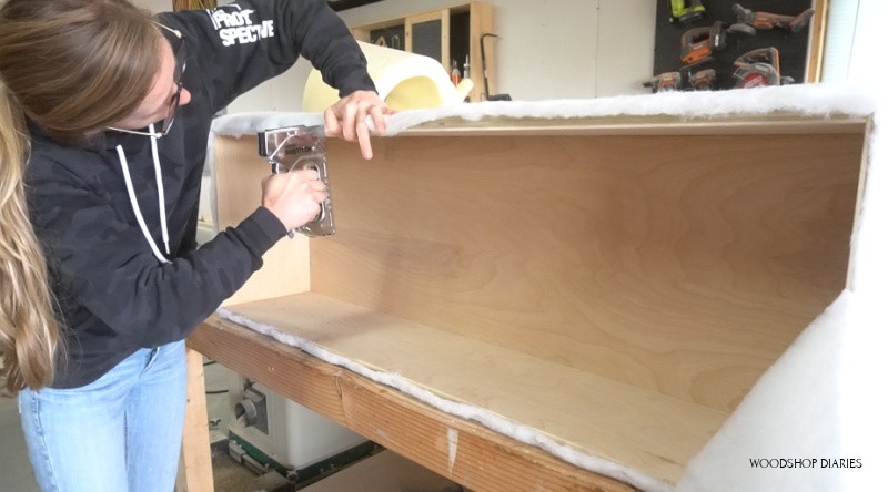 Stapling batting on top edge of upholstered storage bench