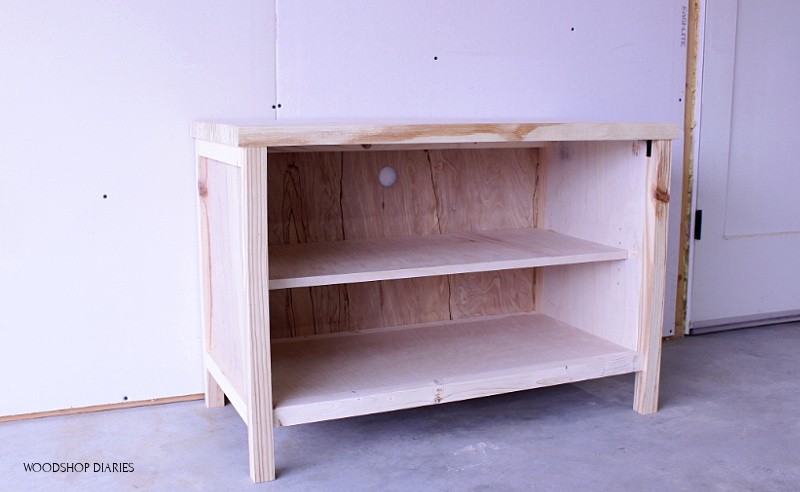 Basic unfinished shelf cabinet for tv stand with hole cut in back