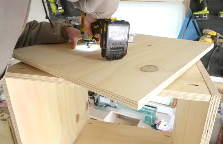 Drilling through access holes in lazy susan to attach onto cabinet bottom