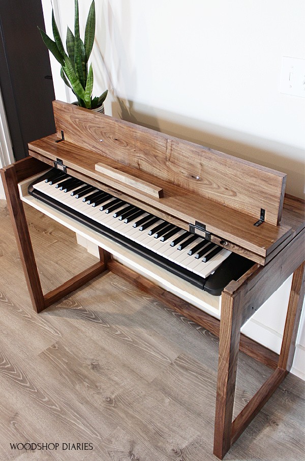 DIY Walnut keyboard stand with top flipped open and keyboard on drawer inside